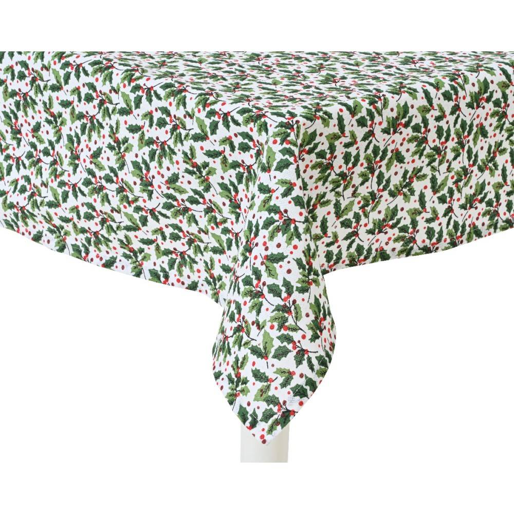 A white tablecloth adorned with green leaves and red berries in a festive pattern.