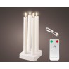 Four white LED candles in a sleek white base, glowing softly with a remote control nearby.