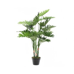 A lush, green faux plant with large, fan-shaped leaves in a simple black pot.