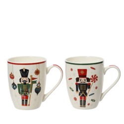 Two festive mugs with nutcracker designs, featuring red and green accents and holiday motifs.