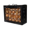 A black box filled with shiny gold and glittery ornaments, showcasing a festive display.