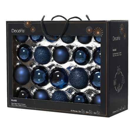 A black box filled with shiny blue glass ornaments in various sizes and textures.