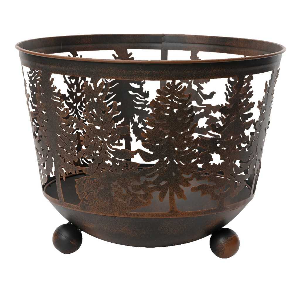 A rustic metal basket with intricate tree cutouts and rounded feet.