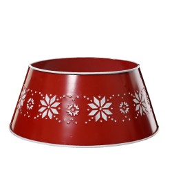 A red metal bowl with white snowflake cutouts around the rim.