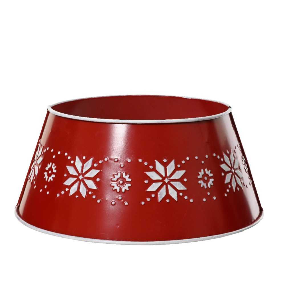 A red metal bowl with white snowflake cutouts around the rim.