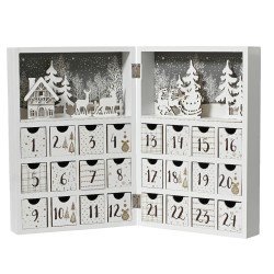 A white advent calendar with small drawers, featuring festive designs and a winter scene.