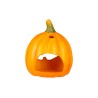A bright orange pumpkin decoration with a carved-out face and green stem.
