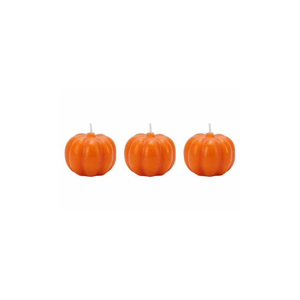Three small, glossy orange pumpkin candles with ridged surfaces and white wicks.