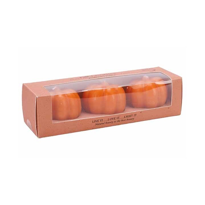 Drie oranje kaarsen in de vorm van pompoenen, verpakt in een doorzichtige doos met kraftpapier.