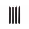 Four slender, black taper candles with pointed tips, arranged upright in a row.