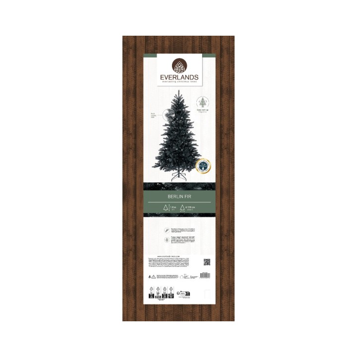 Een elegante kunstkerstboom met een groene tint op een houten achtergrond.