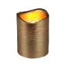 A textured gold candle holder with a warm, flickering glow at the top.