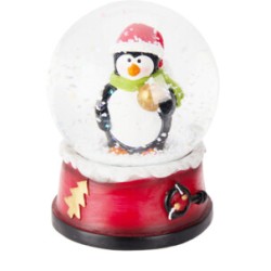 A cheerful penguin in a red hat and green scarf inside a festive snow globe.