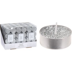A silver candle with sparkles next to a box of matching tealights.