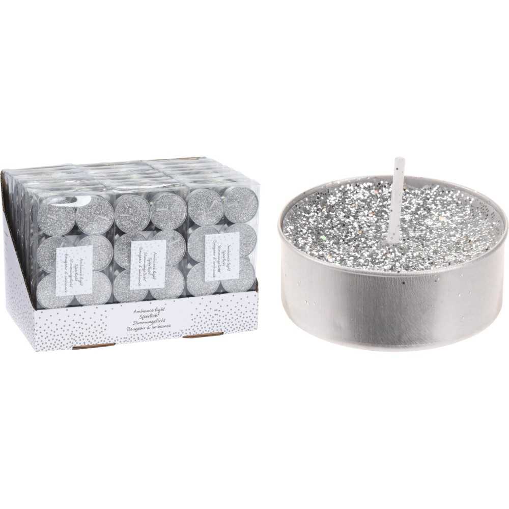 A silver candle with sparkles next to a box of matching tealights.