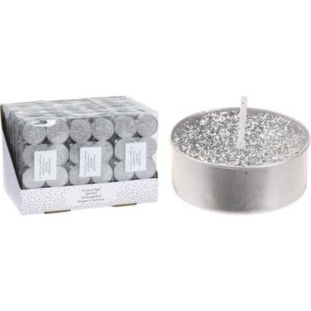 A silver candle with sparkles next to a box of matching tealights.