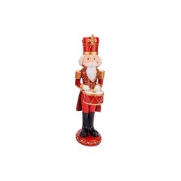 Kleurrijke kerstfiguur van een trommelende nutcracker in rood, goud en zwart.