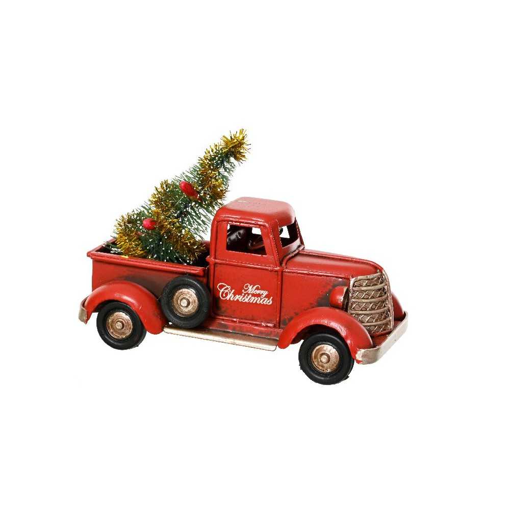 A vintage red truck carries a festive green tree, adorned with gold tinsel and a holiday message.