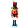 A bear soldier figurine in a red uniform, black hat, and white pants, holding a trumpet.