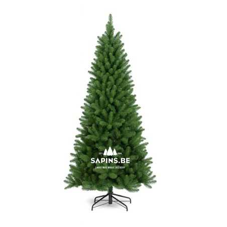 A tall, lush green artificial Christmas tree with a metal base.