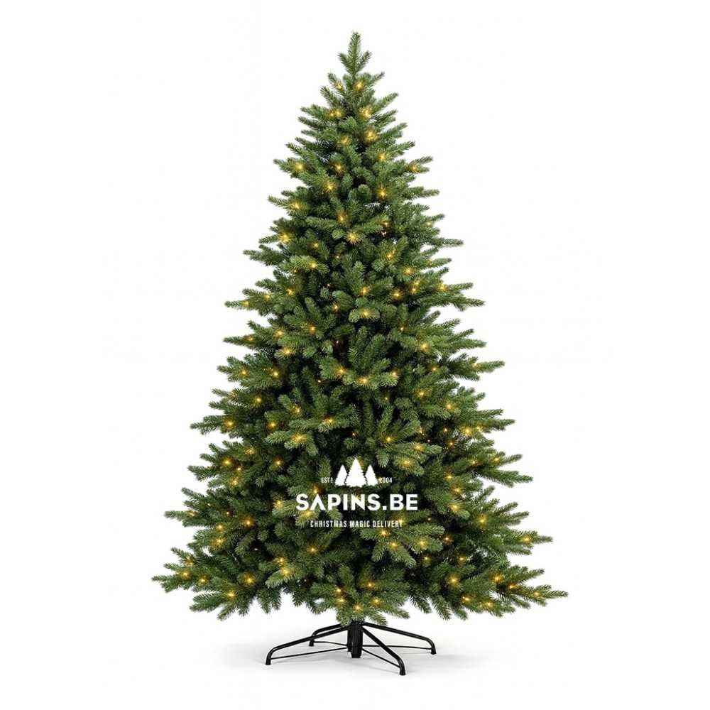 A lush green artificial Christmas tree with warm white lights and a sturdy black stand.