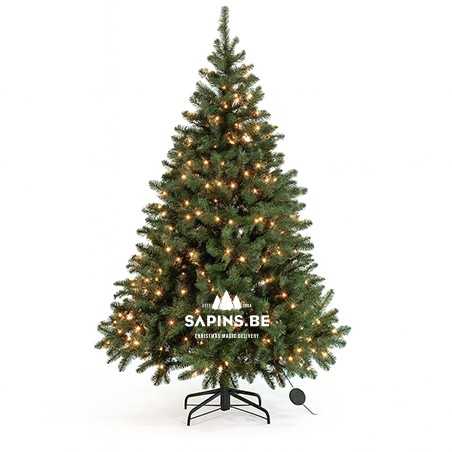 A lush green artificial Christmas tree adorned with warm white lights. A lush green artificial Christmas tree adorned with warm white lights.