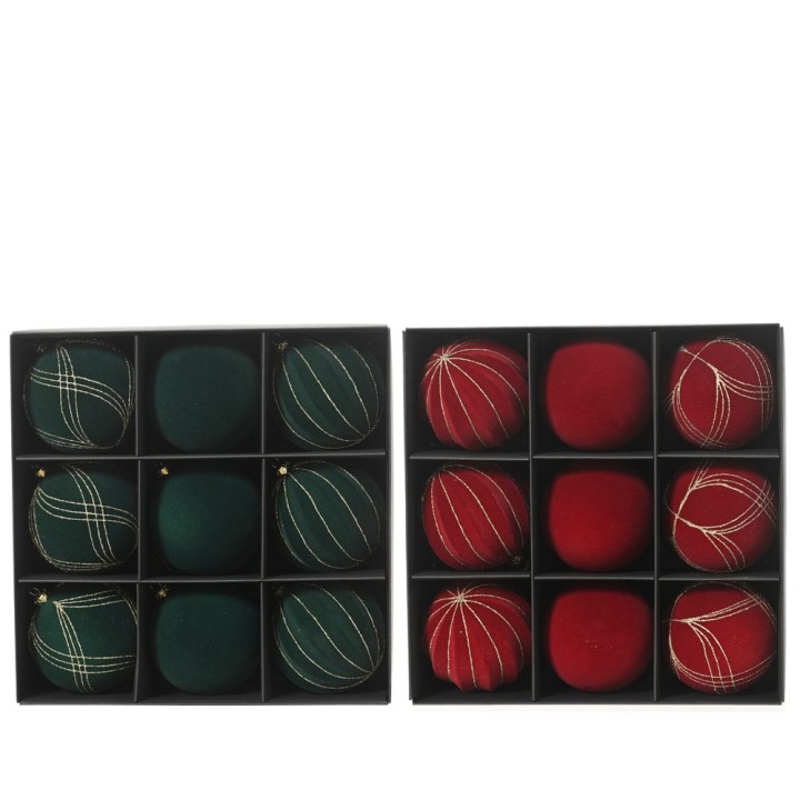 A festive arrangement of green and red ornaments in a black box, featuring various textures.