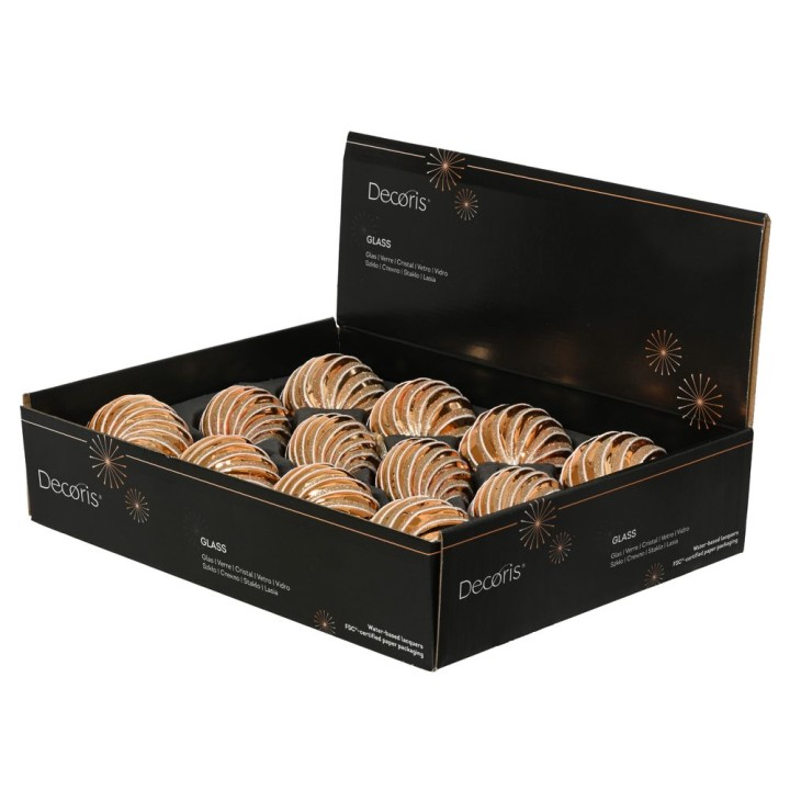 A black box filled with delicate glass ornaments shaped like spirals, featuring warm tones.