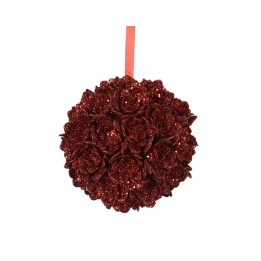 A round, glittery red ornament shaped like roses, suspended by a ribbon.