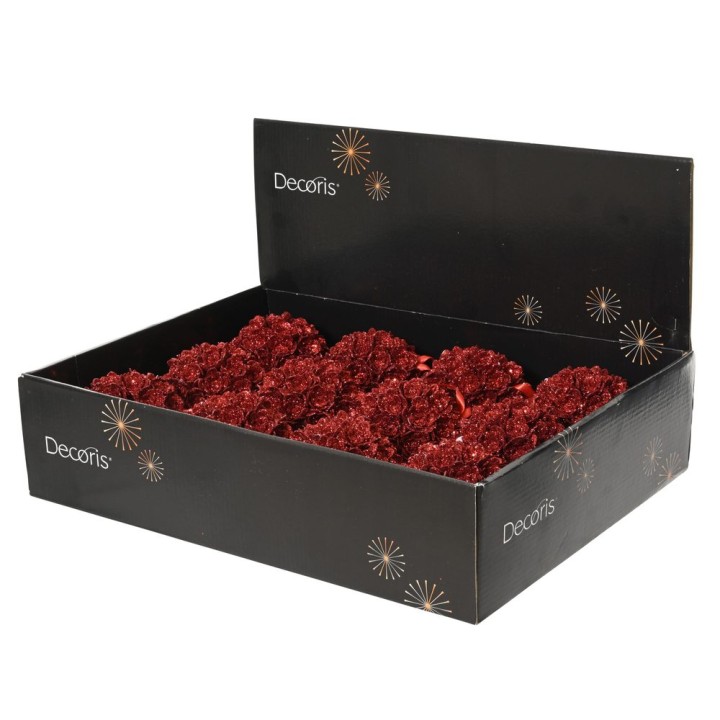 A black display box filled with vibrant red decorative flowers.