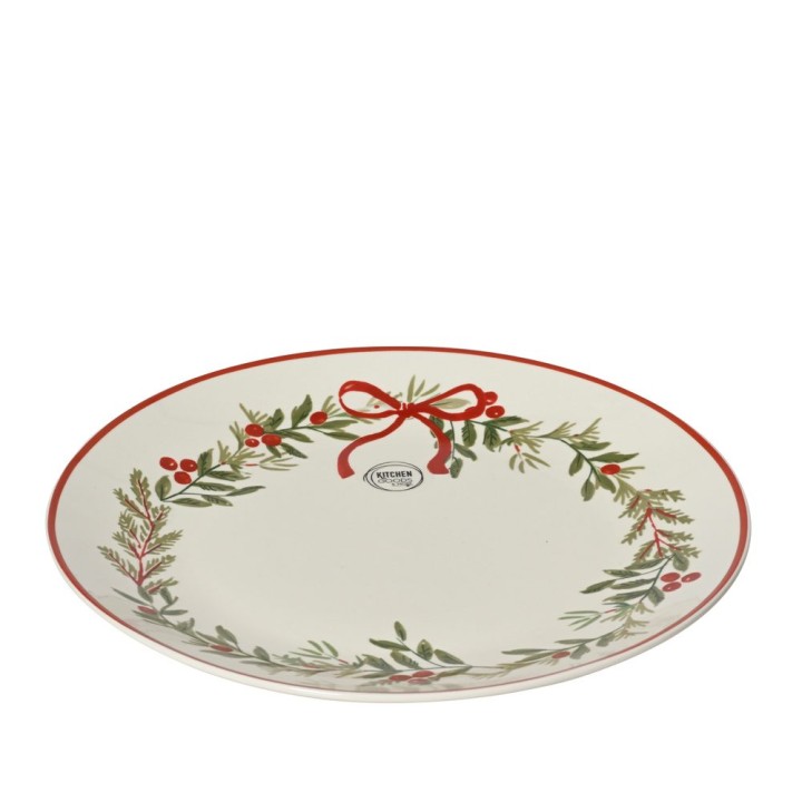 A white oval plate adorned with a red ribbon and green foliage design.