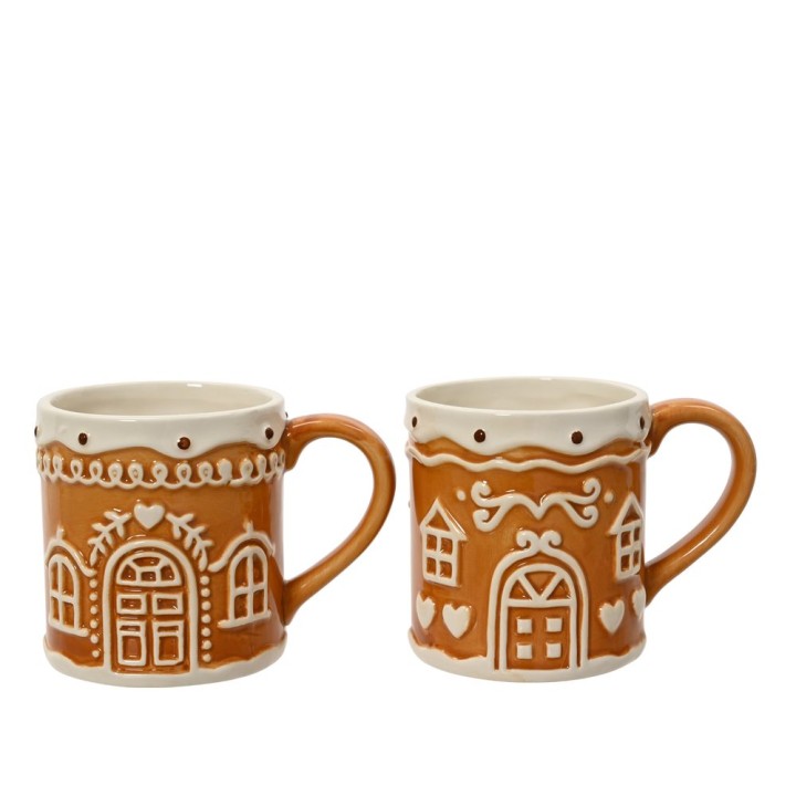 Two whimsical gingerbread-style mugs in warm brown with decorative white icing patterns.