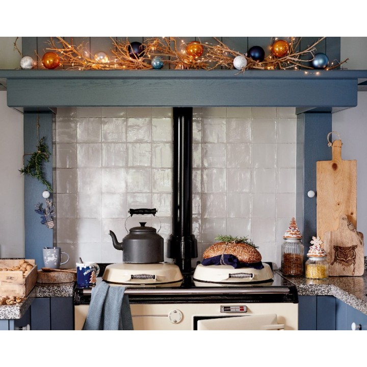 A cozy kitchen scene with a vintage stove, festive decorations, and warm, inviting colors.