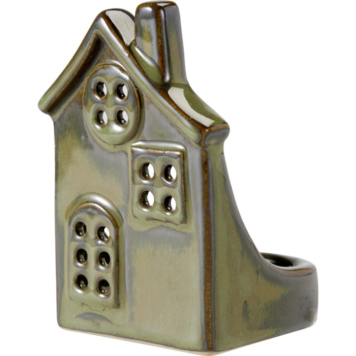 A whimsical ceramic house-shaped holder in earthy green tones with window cutouts.