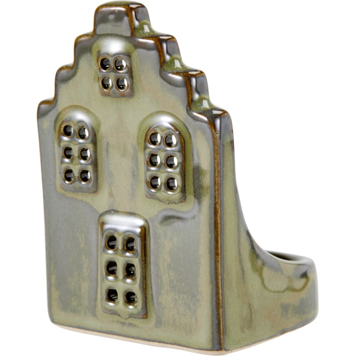 A ceramic piece resembling a stylized house with textured windows and a greenish glaze.