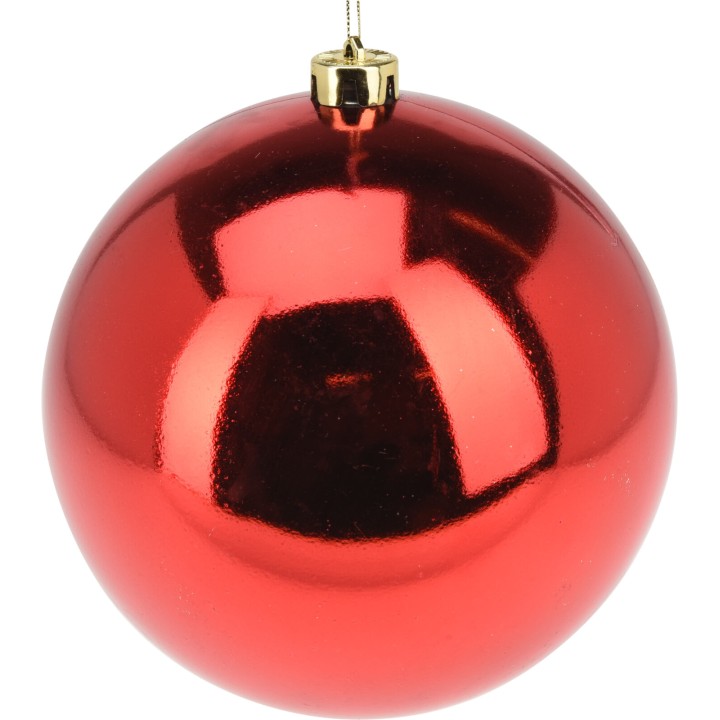 Shiny red Christmas ornament with a gold cap, reflecting light beautifully.
