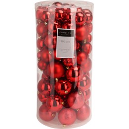 A clear cylinder filled with shiny red Christmas ornaments of various sizes.