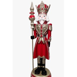 A tall, regal nutcracker in red and gold, holding a spear, with intricate detailing.
