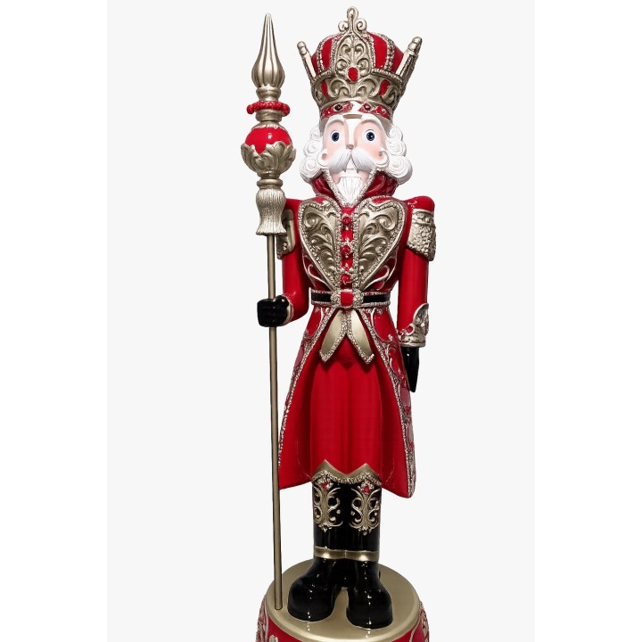 A tall, regal nutcracker in red and gold, holding a spear, with intricate detailing.