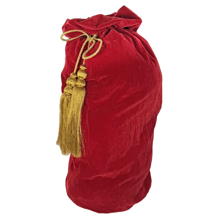 A plush red velvet bag tied with a golden cord and tassels, exuding elegance.