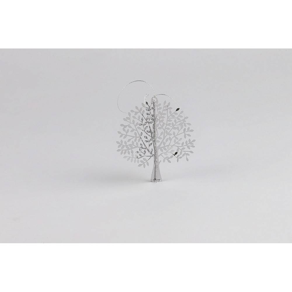 A delicate, white metal tree sculpture with intricate leaf designs and a minimalistic style.