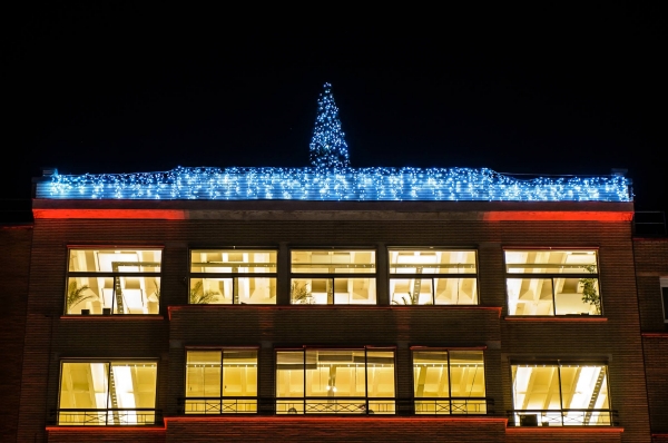 Verlichte kerstboom op een dak